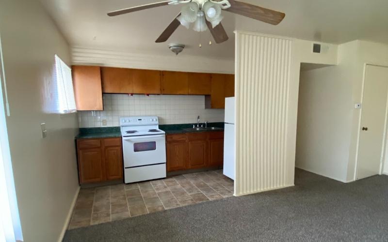 a kitchen with a ceiling fan